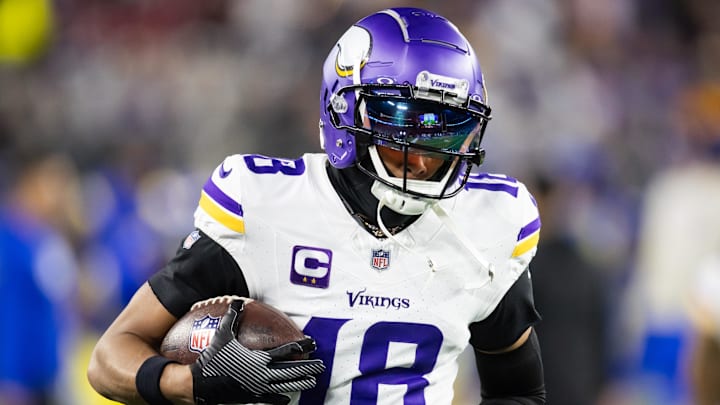 Minnesota Vikings receiver Justin Jefferson runs with the ball during a game.