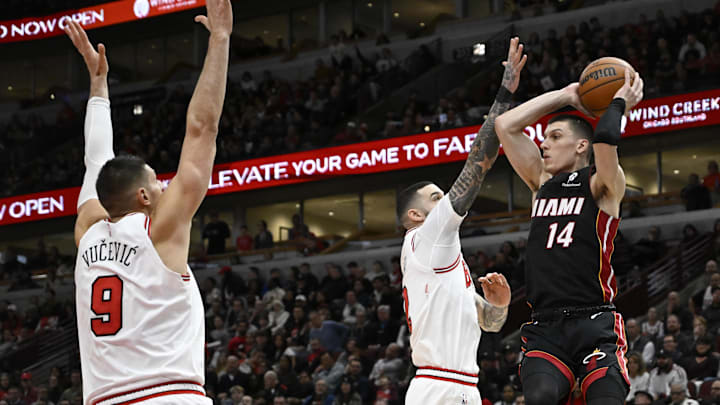 Feb 4, 2025; Chicago, Illinois, USA;  Miami Heat guard Tyler Herro (14)  passes the ball away