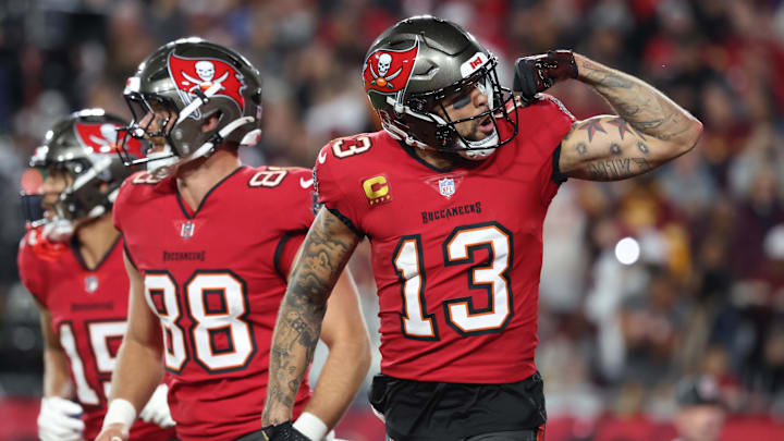 Jan 12, 2025; Tampa, Florida, USA; Tampa Bay Buccaneers wide receiver Mike Evans (13) celebrates after a touchdown catch with tight end Cade Otton (88) during the second quarter of a NFC wild card playoff against the Washington Commanders at Raymond James Stadium. Mandatory Credit: Kim Klement Neitzel-Imagn Images