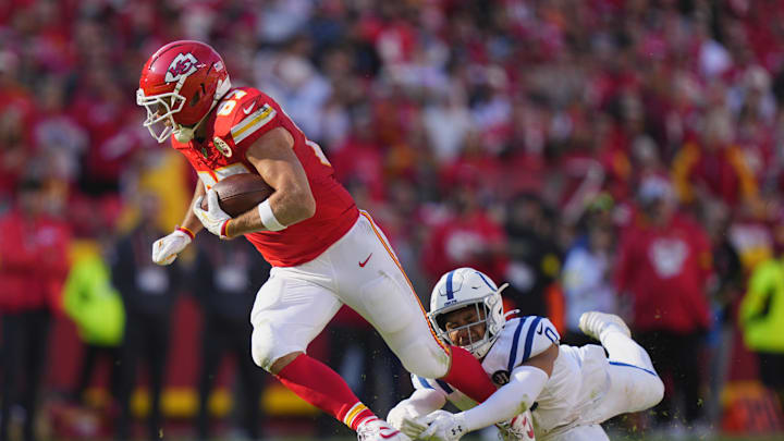 Nov 23, 2025; Kansas City, Missouri, USA; Indianapolis Colts safety Cam Bynum (0) tackles Kansas City Chiefs tight end Travis Kelce (87) in the first half at GEHA Field at Arrowhead Stadium. Mandatory Credit: Jay Biggerstaff-Imagn Images
