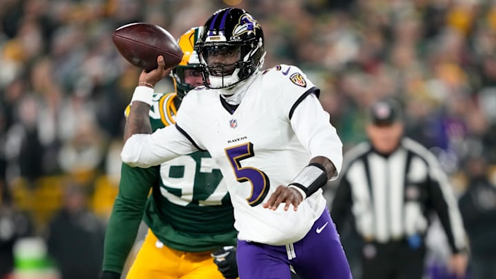 Dec 27, 2025; Green Bay, Wisconsin, USA; Baltimore Ravens quarterback Tyler Huntley (5) looks to throw a pass as Green Bay Packers defensive tackle Jordon Riley (97) defends during the first quarter at Lambeau Field. Mandatory Credit: Kayla Wolf-Imagn Images