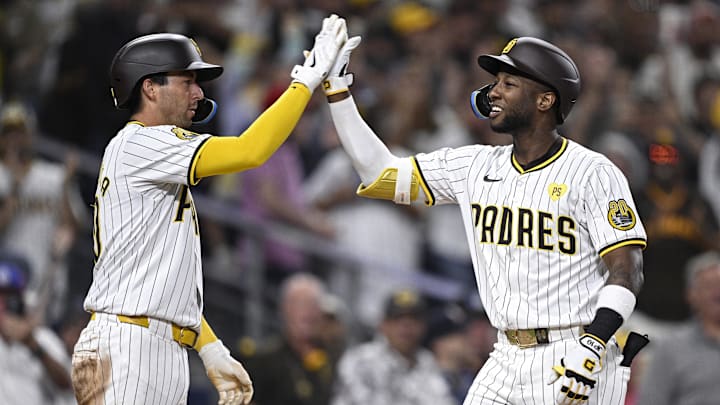 Jun 25, 2024; San Diego, California, USA; San Diego Padres left fielder Jurickson Profar (right) is congratulated by catcher Kyle Higashioka (20) after hitting a grand slam home run against the Washington Nationals during the sixth inning at Petco Park. Mandatory Credit: Orlando Ramirez-Imagn Images