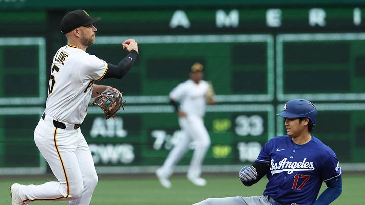 Pittsburgh Pirates second baseman Brandon Lowe turns a double play over Los Angeles Dodgers designated hitter Shohei Ohtani.