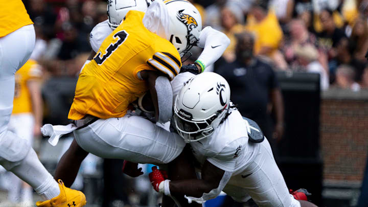 Cincinnati Bearcats linebacker Simeon Coleman (31) tackles Towson Tigers running back Devin Matthews (3) in the second quarter of the College Football game at Nippert Stadium in Cincinnati on Saturday, Aug. 31, 2024.