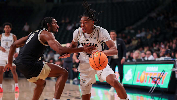 Feb 11, 2026; Atlanta, Georgia, USA; Georgia Tech Yellow Jackets guard Akai Fleming (0) shoots past Wake Forest Demon Deacons guard Mekhi Mason (8) in the second quarter at McCamish Pavilion. Mandatory Credit: Brett Davis-Imagn Imagesdd