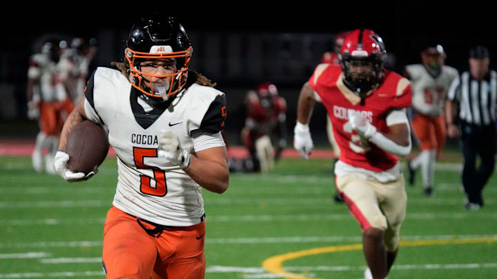 Cocoa High wide receiver Jayvan Boggs (#5) finds room to run against the Cardinal Mooney defense. Cocoa High School defeated Cardinal Mooney Catholic High School 31-21 to win the Class 2A semi-final game Friday night in Sarasota.