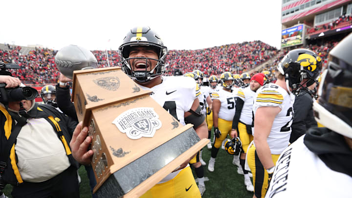 Nov 24, 2023; Lincoln, Nebraska, USA; Iowa Hawkeyes defensive lineman Yahya Black (94) carries the Heroes Trophy after beating the Nebraska Cornhuskers at Memorial Stadium. Nov 24, 2023; Lincoln, Nebraska, USA; Iowa Hawkeyes defensive lineman Yahya Black (94) carries the Heroes Trophy after beating the Nebraska Cornhuskers at Memorial Stadium.