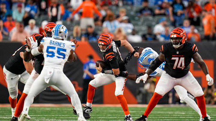 Cincinnati Bengals quarterback Jake Browning (6) fights a tackle as he scrambles in the fourth quarter of the NFL Week 5 game between the Cincinnati Bengals and the Detroit Lions at Paycor Stadium in downtown Cincinnati on Sunday, Oct. 5, 2025. The Bengals continued a losing streak, falling 37-24 to the Lions.