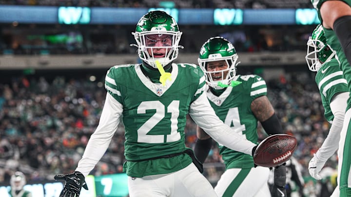 Jan 5, 2025; East Rutherford, New Jersey, USA; New York Jets safety Ashtyn Davis (21) celebrates his interception with teammates during the first half against the Miami Dolphins at MetLife Stadium. Mandatory Credit: Vincent Carchietta-Imagn Images