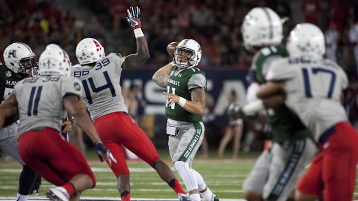 Sep 17, 2016; Tucson, AZ, USA; Hawaii Warriors quarterback Ikaika Woolsey (11) passes the ball against the Arizona Wildcats during the second quarter at Arizona Stadium. Mandatory Credit: Casey Sapio-Imagn Images