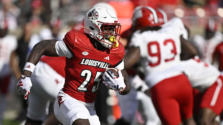 Sep 7, 2024; Louisville, Kentucky, USA;  Louisville Cardinals running back Isaac Brown (25) runs the ball against the Jacksonville State Gamecocks during the second half at L&N Federal Credit Union Stadium. Louisville defeated Jacksonville State 49-14. Mandatory Credit: Jamie Rhodes-Imagn Images