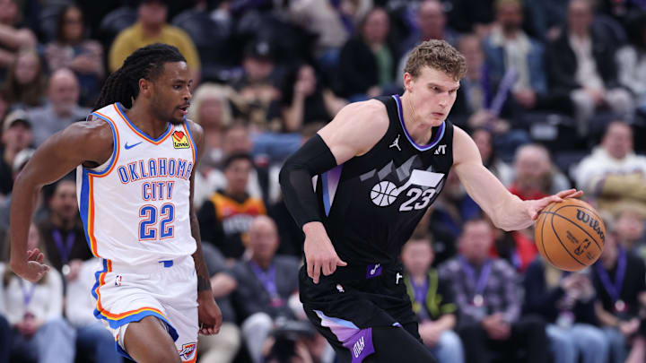 Feb 21, 2025; Salt Lake City, Utah, USA; Utah Jazz forward Lauri Markkanen (23) brings the ball up the court as Oklahoma City Thunder guard Cason Wallace (22) defends during the fourth quarter at Delta Center. Mandatory Credit: Rob Gray-Imagn Images