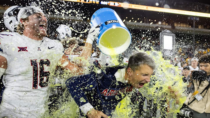 Nov 28, 2025; Tempe, Arizona, USA; Arizona Wildcats head coach Brent Brennan is doused with Powerade after defeating the Arizona State Sun Devils during the 99th Territorial Cup at Mountain America Stadium. Mandatory Credit: Mark J. Rebilas-Imagn Images Nov 28, 2025; Tempe, Arizona, USA; Arizona Wildcats head coach Brent Brennan is doused with Powerade after defeating the Arizona State Sun Devils during the 99th Territorial Cup at Mountain America Stadium. Mandatory Credit: Mark J. Rebilas-Imagn Images