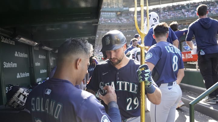 Seattle Mariners catcher Cal Raleigh (29) is greeted in the dugout after hitting a home run against the Chicago Cubs during the ninth inning at Wrigley Field on June 22. 