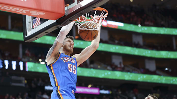Dec 1, 2024; Houston, Texas, USA; Oklahoma City Thunder center Isaiah Hartenstein (55) dunks the ball as Houston Rockets center Alperen Sengun (28) defends during the first quarter at Toyota Center.
