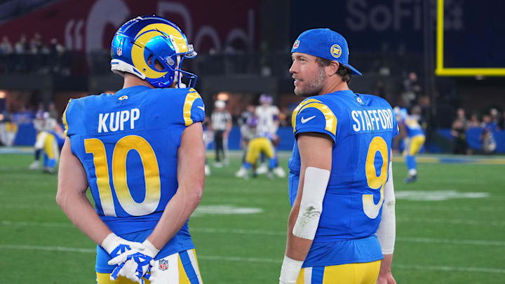 Jan 13, 2025; Glendale, AZ, USA; Los Angeles Rams quarterback Matthew Stafford (9) and wide receiver Cooper Kupp (10) watch from the sidelines against the Minnesota Vikings during the second half in an NFC wild card game at State Farm Stadium. Mandatory Credit: Joe Camporeale-Imagn Images