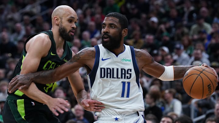 Feb 6, 2025; Boston, Massachusetts, USA; Dallas Mavericks guard Kyrie Irving (11) drives the ball against Boston Celtics guard Derrick White (9) in the first quarter at TD Garden. Mandatory Credit: David Butler II-Imagn Images