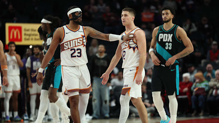 Feb 3, 2026; Portland, Oregon, USA;  Phoenix Suns guard Jordan Goodwin (23) recognizes teammate guard Collin Gillespie (12) during the second half against the Portland Trail Blazers at Moda Center. Mandatory Credit: Jaime Valdez-Imagn Images