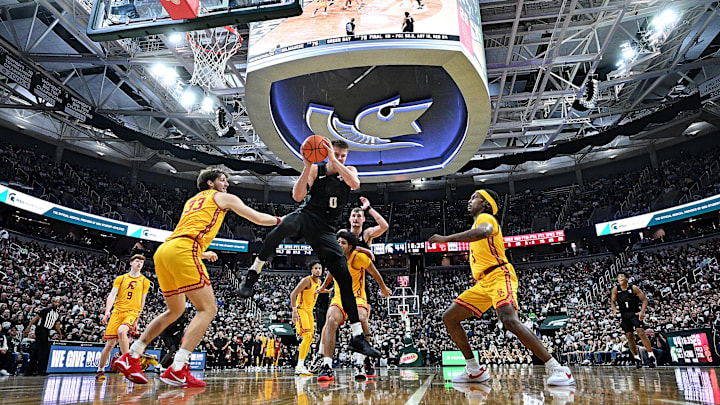 Jan 5, 2026; East Lansing, Michigan, USA;  Ringed by Southern California Trojans defenders, Michigan State Spartans forward Jaxon Kohler (0) comes down with an offensive rebound during the second half at Jack Breslin Student Events Center.