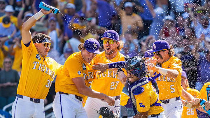 The LSU Tigers celebrate after defeating the Coastal Carolina Chanticleers to win the championship at Charles Schwab Field. 