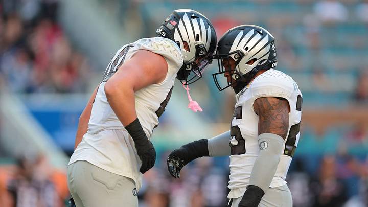 Jan 1, 2026; Miami Gardens, FL, USA; Oregon Ducks linebacker Teitum Tuioti (44) reacts with linebacker Devon Jackson (26) after a sack against the Texas Tech Red Raiders during the second half of the 2025 Orange Bowl and quarterfinal game of the College Football Playoff at Hard Rock Stadium. Mandatory Credit: Sam Navarro-Imagn Images
