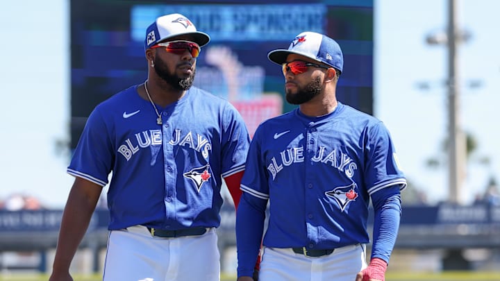 Mar 2, 2025; Dunedin, Florida, USA; Toronto Blue Jays first baseman Vladimir Guerrero Jr. (27) and Toronto Blue Jays outfielder Steward Berroa (37) warm up before a game against the Philadelphia Phillie during spring training at TD Ballpark.