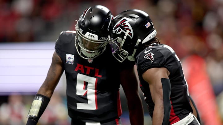 Atlanta Falcons running back Bijan Robinson celebrates with quarterback Michael Penix Jr.