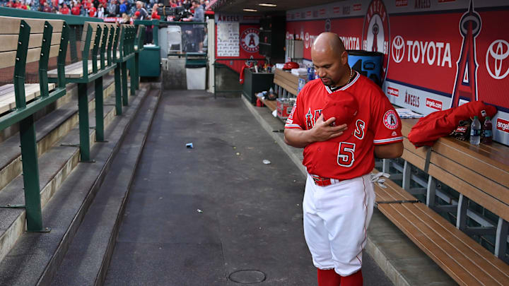 Los Angeles Angels first baseman Albert Pujols in the dugout during the national anthem before the start of a game against the Texas Rangers at Angel Stadium of Anaheim on Apr 5, 2019. Los Angeles Angels first baseman Albert Pujols in the dugout during the national anthem before the start of a game against the Texas Rangers at Angel Stadium of Anaheim on Apr 5, 2019.