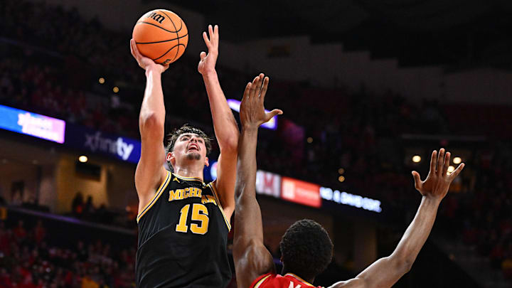 Dec 13, 2025; College Park, Maryland, USA;  Michigan Wolverines center Aday Mara (15) shoots over Maryland Terrapins forward Pharrel Payne (21) in the first half at Xfinity Center. Mandatory Credit: Jamie Sabau-Imagn Images