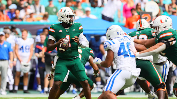 Nov 2, 2024; Miami Gardens, Florida, USA; Miami Hurricanes quarterback Cam Ward (1) looks for a passing option against the Duke Blue Devils during the second quarter at Hard Rock Stadium. Mandatory Credit: Sam Navarro-Imagn Images