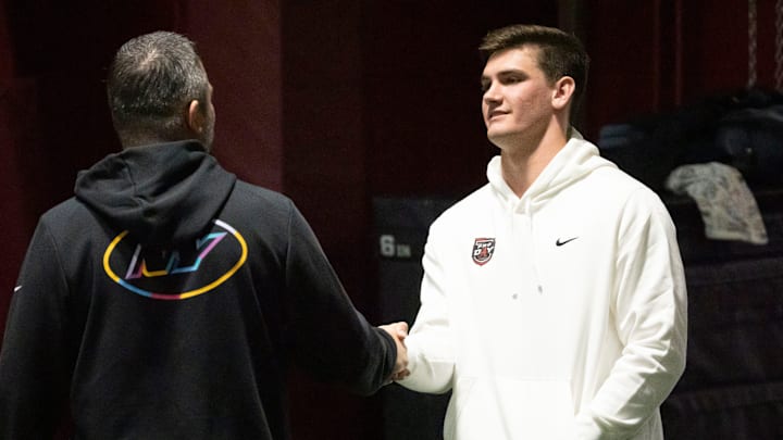 March 25, 2026; Tuscaloosa, AL, USA; Quarterback Ty Simpson talks to a scout during Pro Day in the Hank Crisp Indoor Practice Facility at the University of Alabama. March 25, 2026; Tuscaloosa, AL, USA; Quarterback Ty Simpson talks to a scout during Pro Day in the Hank Crisp Indoor Practice Facility at the University of Alabama.