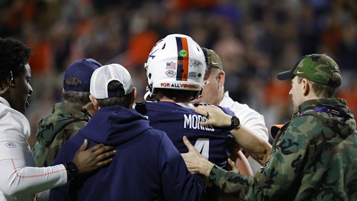Nov 8, 2025; Charlottesville, Virginia, USA; Virginia Cavaliers quarterback Chandler Morris (4) is escorted off the field by medical staff after being injured against the Wake Forest Demon Deacons during the first half at Scott Stadium. Mandatory Credit: Amber Searls-Imagn Images