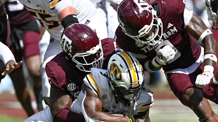 Oct 5, 2024; College Station, Texas, USA; Texas A&M Aggies defensive lineman Albert Regis (17) and linebacker Scooby Williams (0) stop Missouri Tigers running back Marcus Carroll (9) in the fourth quarter at Kyle Field. Mandatory Credit: Maria Lysaker-Imagn Images. Oct 5, 2024; College Station, Texas, USA; Texas A&M Aggies defensive lineman Albert Regis (17) and linebacker Scooby Williams (0) stop Missouri Tigers running back Marcus Carroll (9) in the fourth quarter at Kyle Field. Mandatory Credit: Maria Lysaker-Imagn Images.
