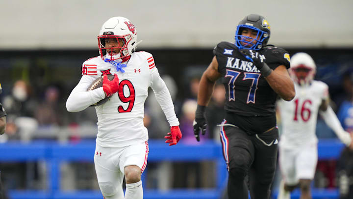 Utah Utes cornerback Elijah Davis (9) returns an interception for a touchdown during the second half against the Kansas Jayhawks at David Booth Kansas Memorial Stadium.