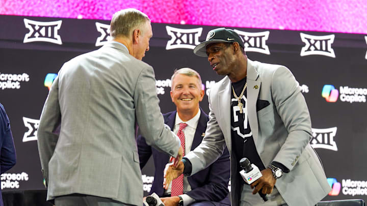 Jul 9, 2025; Frisco, TX, USA; Houston head coach Willie Fritz shakes the hand of Colorado head coach Deion Sanders on stage while Arizona head coach Brent Brennan looks on during 2025 Big 12 Football Media Days at The Star. Mandatory Credit: Raymond Carlin III-Imagn Images Jul 9, 2025; Frisco, TX, USA; Houston head coach Willie Fritz shakes the hand of Colorado head coach Deion Sanders on stage while Arizona head coach Brent Brennan looks on during 2025 Big 12 Football Media Days at The Star. Mandatory Credit: Raymond Carlin III-Imagn Images