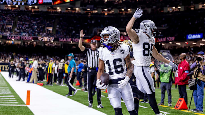 Dec 29, 2024; New Orleans, Louisiana, USA; Las Vegas Raiders wide receiver Jakobi Meyers (16) runs in from a touchdown against New Orleans Saints cornerback Alontae Taylor (1) during the first half at Caesars Superdome. Mandatory Credit: Stephen Lew-Imagn Images Dec 29, 2024; New Orleans, Louisiana, USA; Las Vegas Raiders wide receiver Jakobi Meyers (16) runs in from a touchdown against New Orleans Saints cornerback Alontae Taylor (1) during the first half at Caesars Superdome. Mandatory Credit: Stephen Lew-Imagn Images