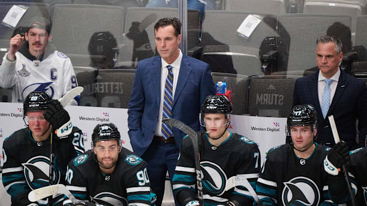 Mar 21, 2024; San Jose, California, USA; San Jose Sharks head coach David Quinn (center) and