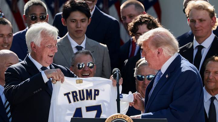 Mark Walter, CEO of Guggenheim Partners, presents U.S. President Donald Trump with a jersey with Trump's surname and a number "47", during a reception for the reigning Major League Baseball (MLB) World Series champion Los Angeles Dodgers in the Rose Garden at the White House, Washington, D.C., U.S., July 23, 2026. REUTERS/Evelyn Hockstein Mark Walter, CEO of Guggenheim Partners, presents U.S. President Donald Trump with a jersey with Trump's surname and a number "47", during a reception for the reigning Major League Baseball (MLB) World Series champion Los Angeles Dodgers in the Rose Garden at the White House, Washington, D.C., U.S., July 23, 2026. REUTERS/Evelyn Hockstein
