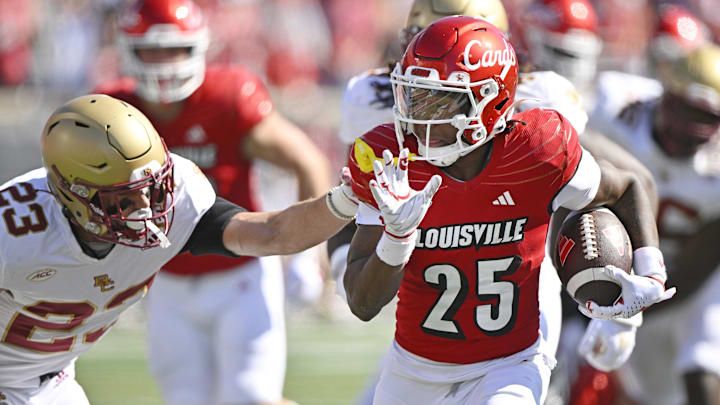 Sep 23, 2023; Louisville, Kentucky, USA; Louisville Cardinals running back Jawhar Jordan (25) avoids the tackle of Boston College Eagles defensive back Cole Batson (23) to run in a touchdown during the first quarter at L&N Federal Credit Union Stadium. Mandatory Credit: Jamie Rhodes-Imagn Images Sep 23, 2023; Louisville, Kentucky, USA; Louisville Cardinals running back Jawhar Jordan (25) avoids the tackle of Boston College Eagles defensive back Cole Batson (23) to run in a touchdown during the first quarter at L&N Federal Credit Union Stadium. Mandatory Credit: Jamie Rhodes-Imagn Images