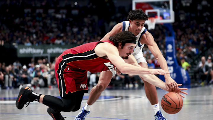 Feb 13, 2025; Dallas, Texas, USA;  Dallas Mavericks guard Max Christie (00) and Miami Heat guard Jaime Jaquez Jr. (11) go for a loose ball during the first half at American Airlines Center. Mandatory Credit: Kevin Jairaj-Imagn Images