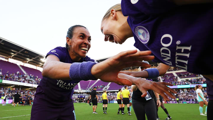 Orlando Pride forward Marta (left) and Orlando Pride defender Carrie Lawrence (right) celebrate after defeating the Kansas City Current in a NWSL playoff semifinal match.