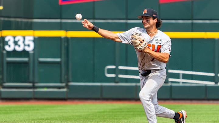 Jun 17, 2025; Omaha, Neb, USA; Oregon State Beavers second baseman AJ Singer (7) throws to first for an out to end the fifth inning against the Louisville Cardinals at Charles Schwab Field. Mandatory Credit: Dylan Widger-Imagn Images