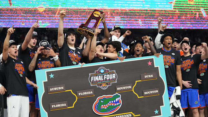 Apr 7, 2025; San Antonio, TX, USA;  Florida Gators players celebrate with the trophy after defeating the Houston Cougars in the national championship game of the Final Four of the 2025 NCAA Tournament at the Alamodome. Mandatory Credit: Robert Deutsch-Imagn Images