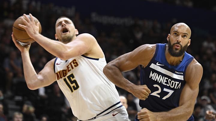 Oct 4, 2025; San Diego, California, USA; Denver Nuggets center Nikola Jokic (15) is fouled by Minnesota Timberwolves center Rudy Gobert (27) during the first half at Pechanga Arena. Mandatory Credit: Denis Poroy-Imagn Images