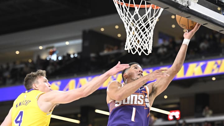 Oct 3, 2025; Palm Desert, California, USA; Phoenix Suns guard Devin Booker (1) shoots past Los Angeles Lakers guard Dalton Knecht (4) at Acrisure Arena. Mandatory Credit: Denis Poroy-Imagn Images