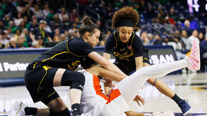Notre Dame guard Hannah Hidalgo, right, forward Gisela Sanchez, left, and Virginia Tech forward Kilah Freelon, center, fight for a loose ball during a NCAA women's basketball game at Purcell Pavilion on Thursday, February. 5, 2026, in South Bend.