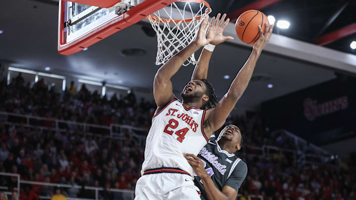 Dec 7, 2024; Queens, New York, USA;  St. John's basketball forward Zuby Ejiofor (24) drives past Kansas State Wildcats center Ugonna Onyenso (34) in the second half at Carnesecca Arena. 