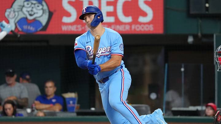 Aug 23, 2026; Arlington, Texas, USA;  Texas Rangers left fielder Wyatt Langford (36) follows through on his double against the Los Angeles Angels during the fifth inning at Globe Life Field.  Mandatory Credit: Jim Cowsert-Imagn Images