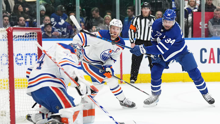 Mar 11, 2023; Toronto, Ontario, CAN; Edmonton Oilers center Connor McDavid (97) battles in front of his team's net against Auston Matthews of the Toronto Maple Leafs.