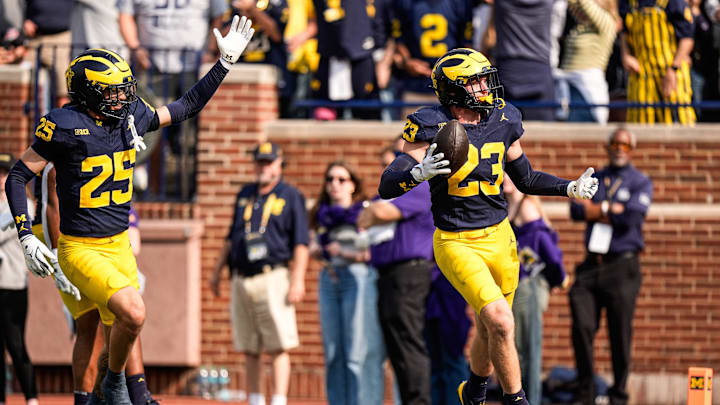 Michigan linebacker Cole Sullivan (23) celebrates an interception against Washington during the second half at Michigan Stadium in Ann Arbor on Saturday, Oct. 18, 2025. Michigan linebacker Cole Sullivan (23) celebrates an interception against Washington during the second half at Michigan Stadium in Ann Arbor on Saturday, Oct. 18, 2025.